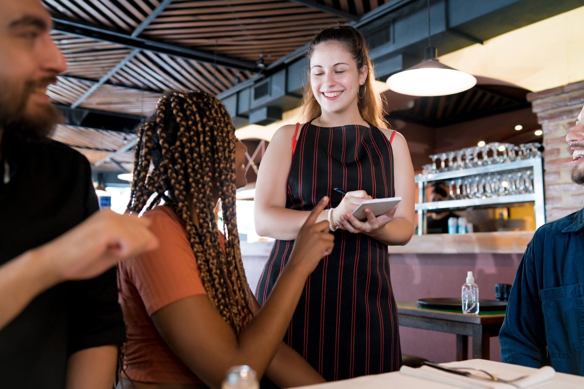 friends-ordering-food-to-the-waitress-at-a-restaur-2021-09-07-16-38-14-utc-1-scaled